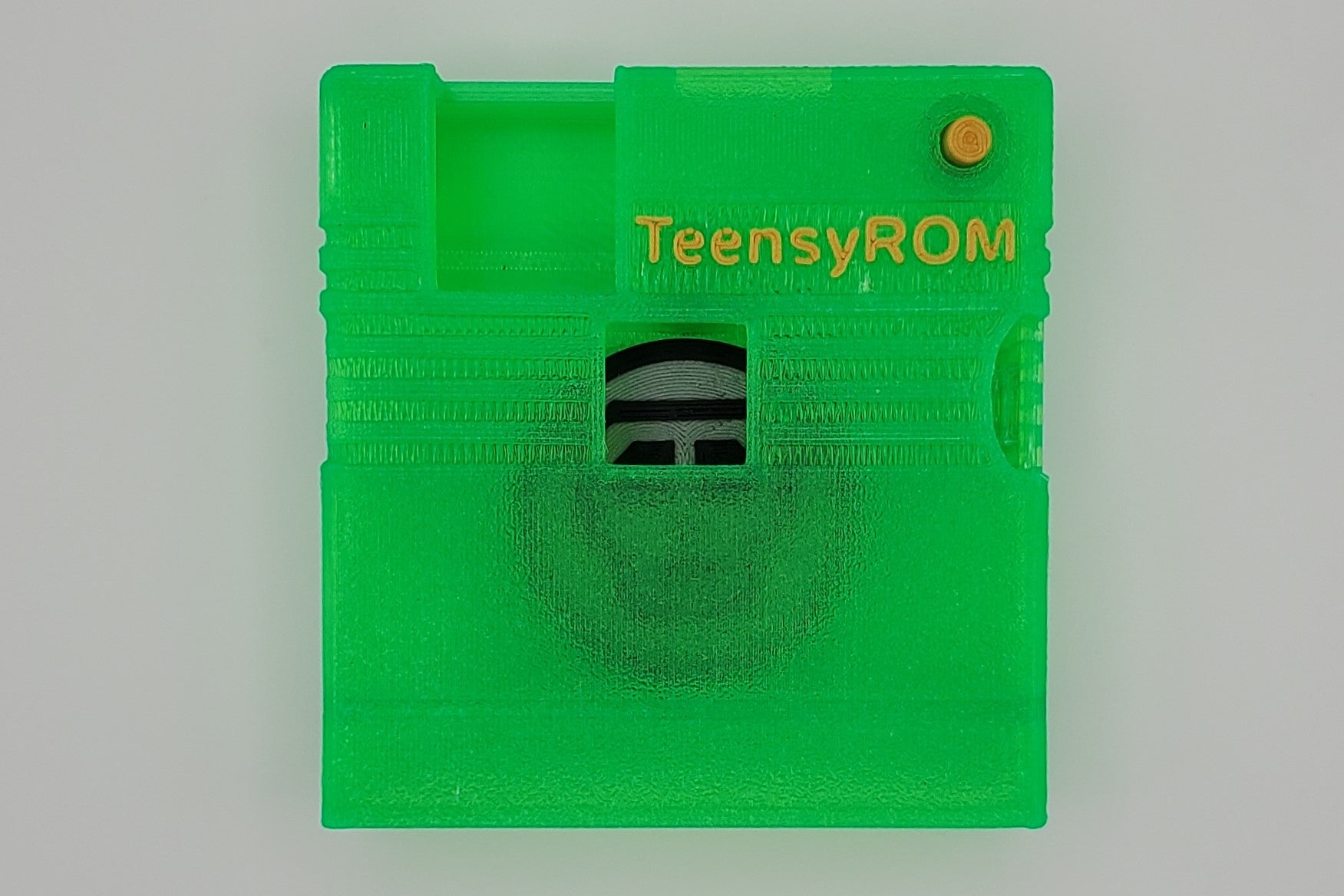TeensyROM cartridge case in green, top view showing transparency
