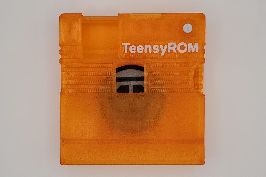 TeensyROM cartridge case in orange, top view showing transparency