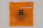 TeensyROM cartridge case in orange, top view showing transparency