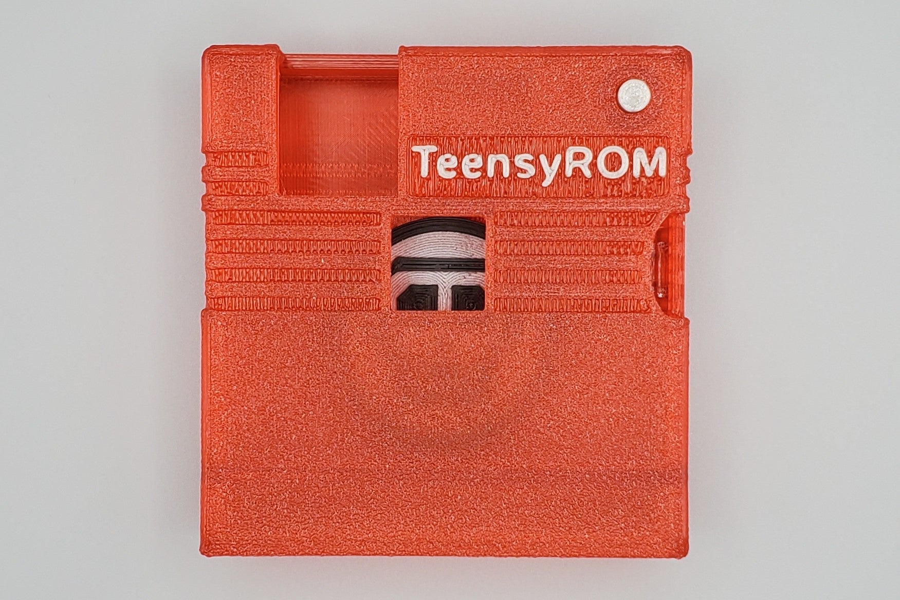 TeensyROM cartridge case in red, top view showing transparency