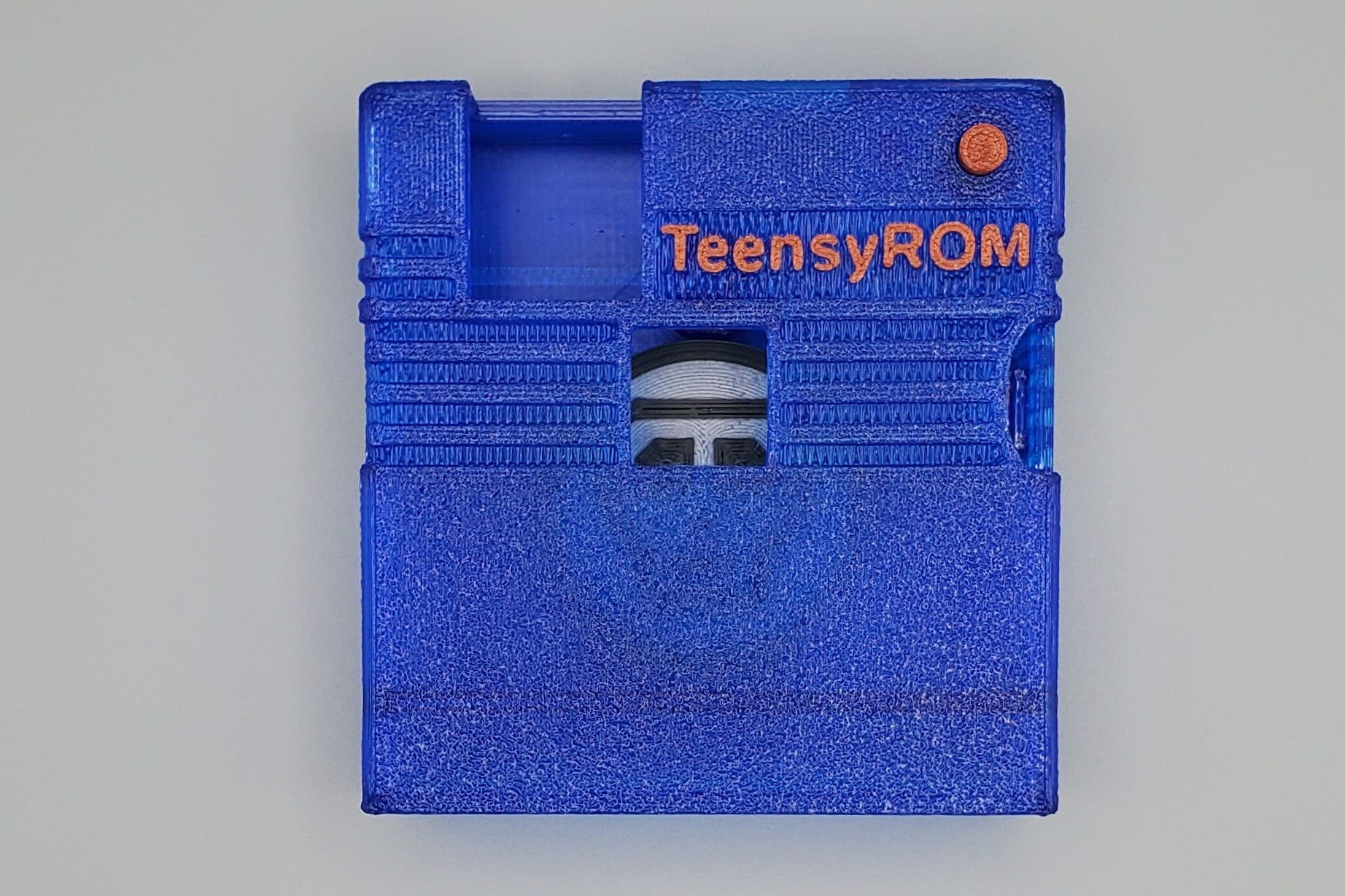 TeensyROM cartridge case in blue, top view showing transparency