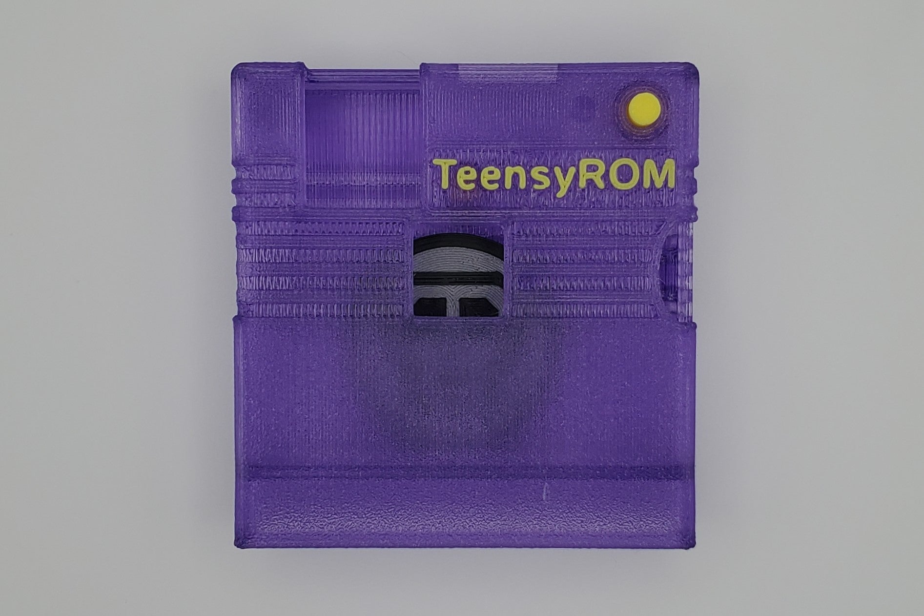 TeensyROM cartridge case in purple, top view showing transparency