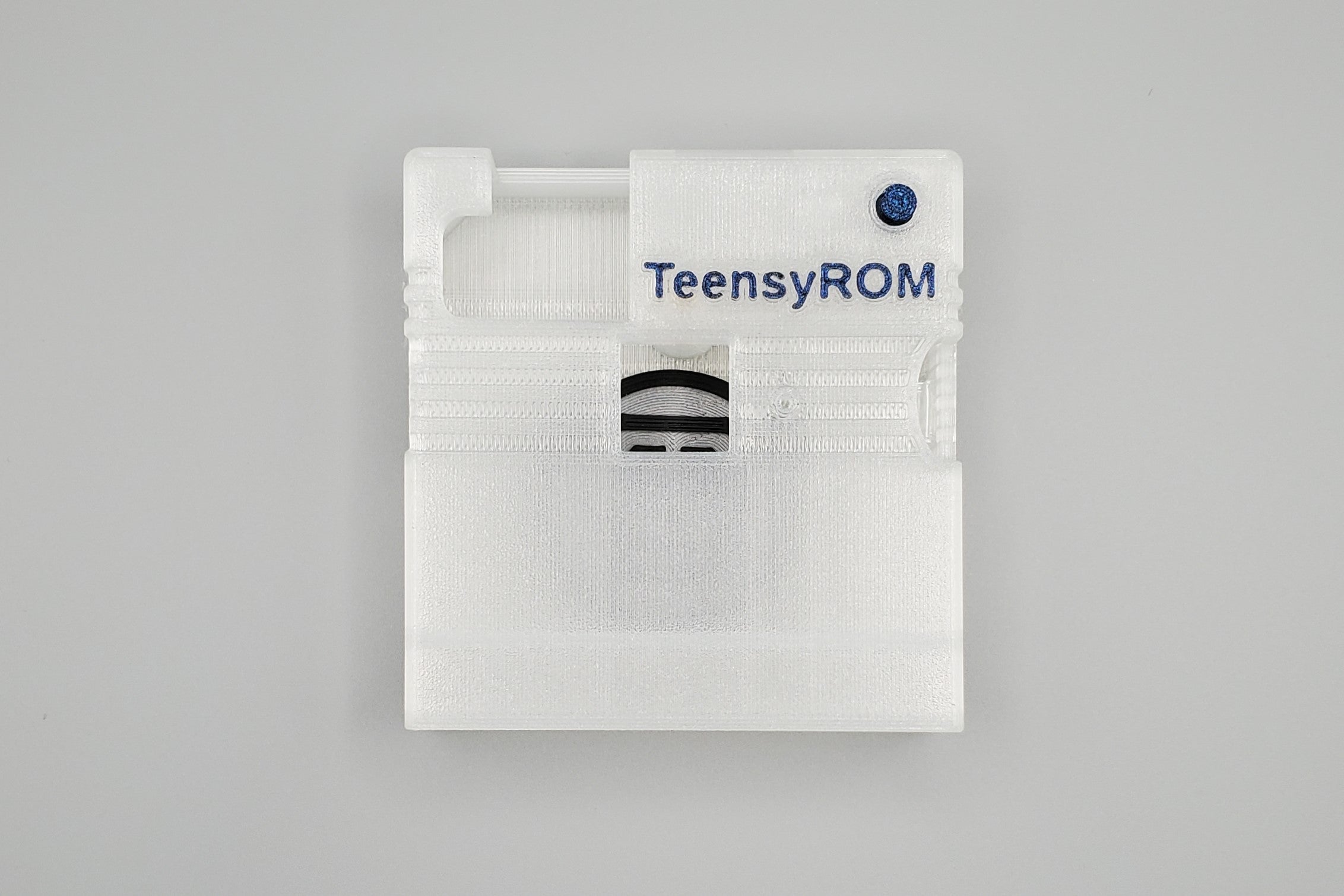 TeensyROM cartridge case in clear, top view showing transparency